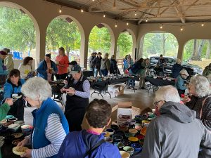 Sep-21-2024-04-DL Photo of the people picking out their bowls as the volunteers assist them.