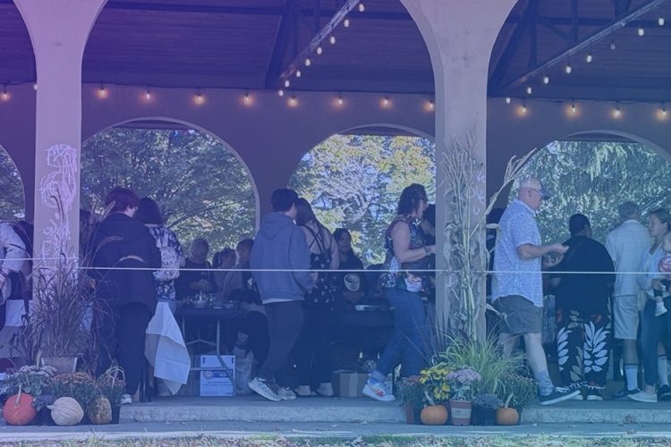 Side view of the Newell Shelter in Capron Park during the 2025 Empty Bowls Event. A purple and blue gradient overlay of the photo.